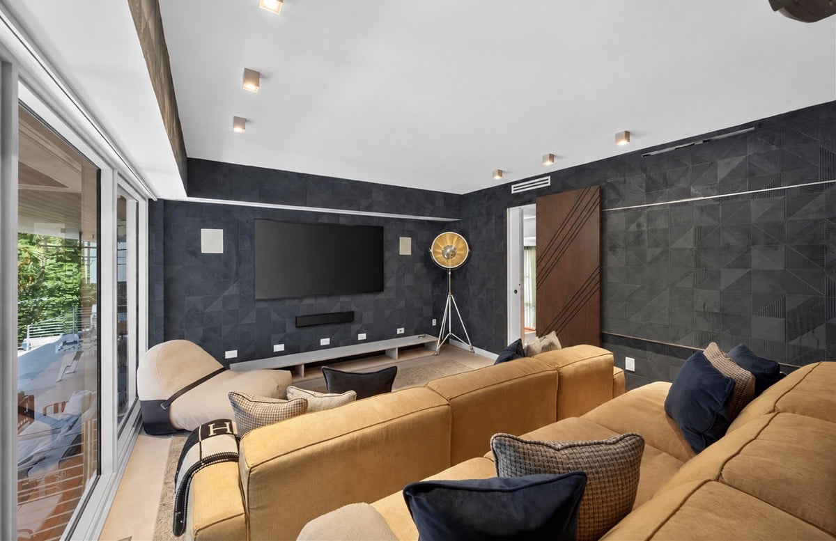Modern living room featuring a custom walnut sliding door with diagonal routed lines and concealed hardware