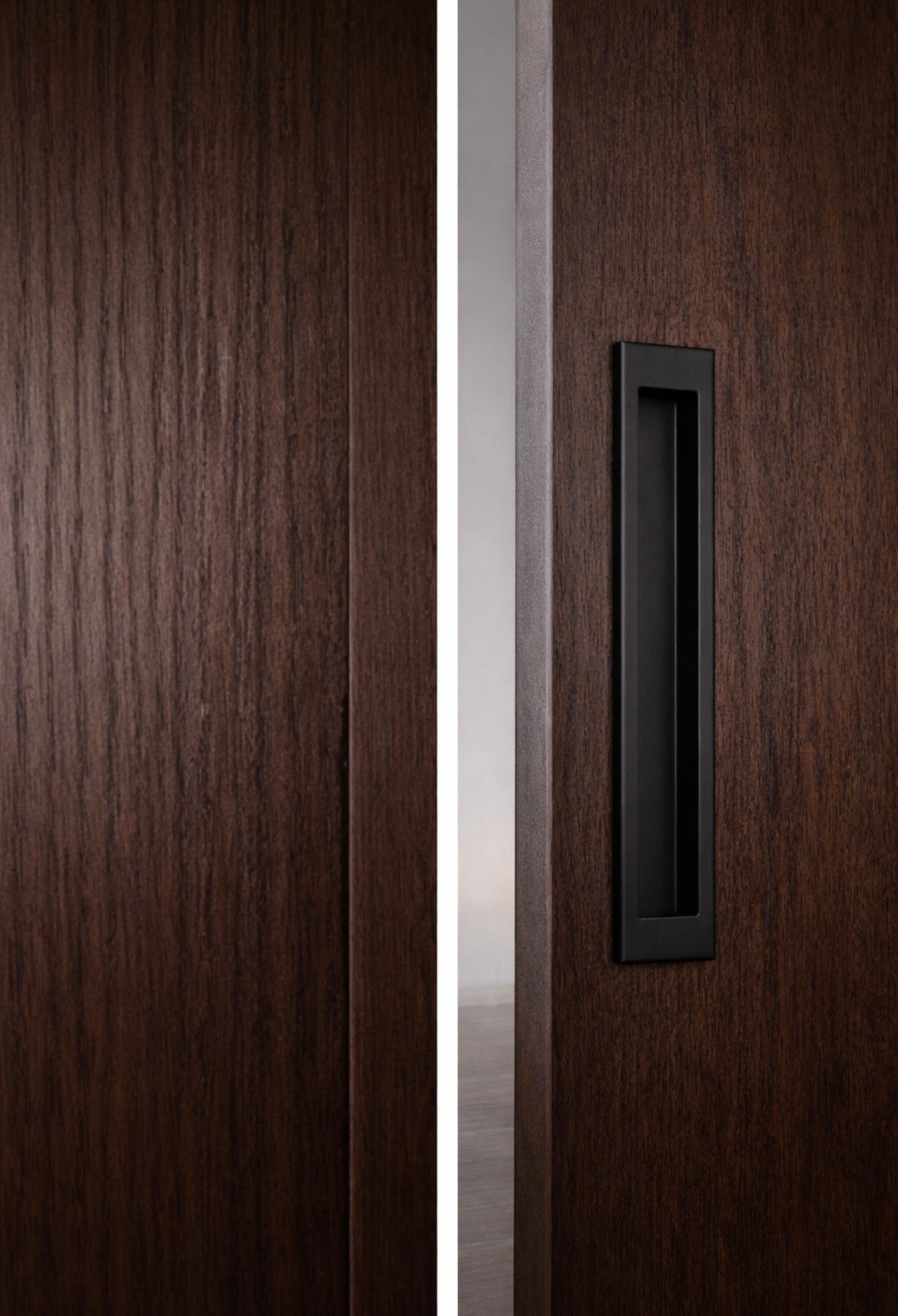 Rift white oak sliding door with tobacco stain and concealed hidden track, modern architectural interior door with asymmetrical panel design