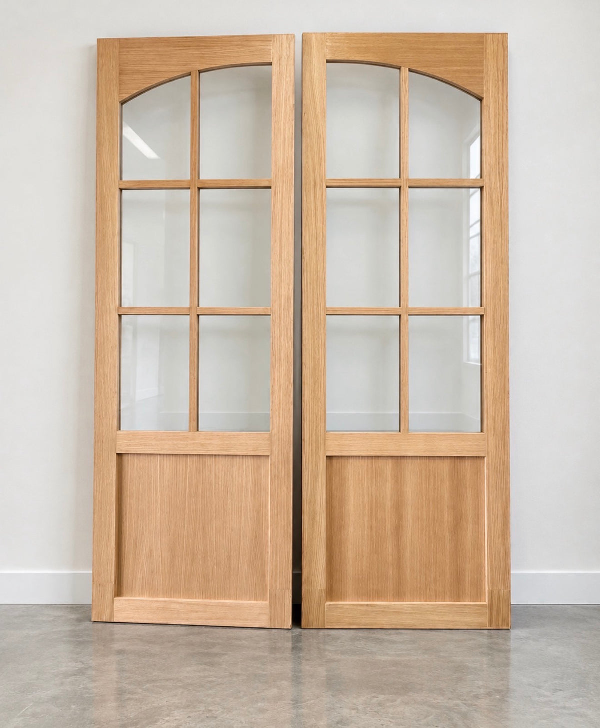Tuscan arched glass door in Rift White Oak with natural stain and clear tempered glass by Rustic Luxe Designs