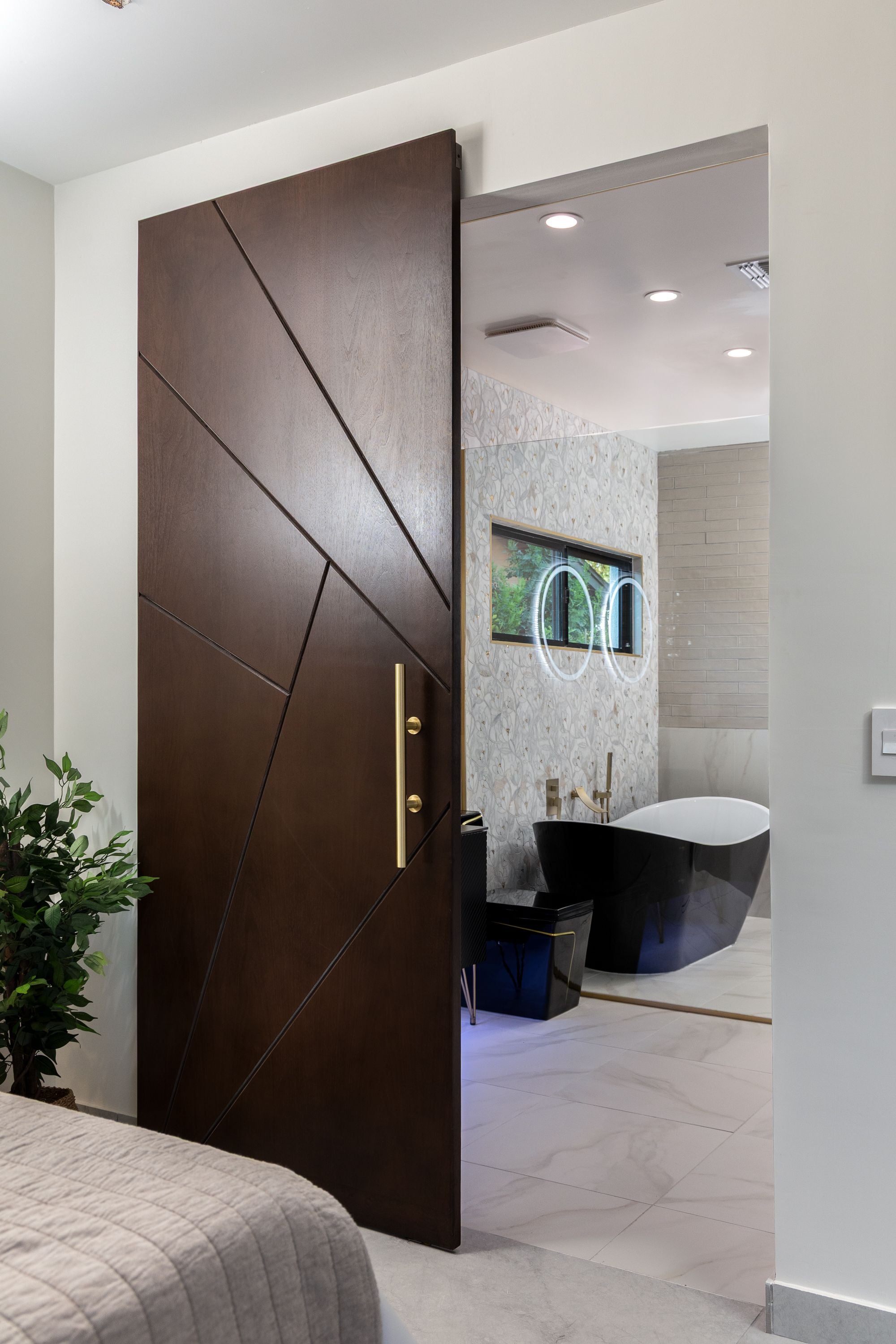 Luxury walnut architectural interior door with geometric routed design and gold handle by Rustic Luxe Designs