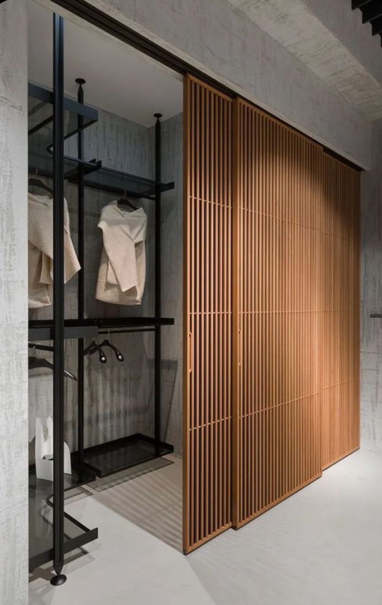 Modern wood slat closet door with vertical slats for airflow and ventilation, custom interior door by Rustic Luxe Designs.