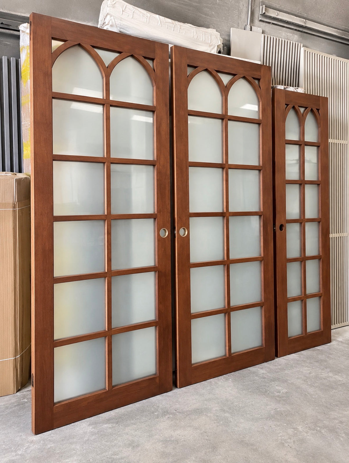 Framed Arabesque interior glass doors in Alder with Cinnamon stain and tempered glass, side angle view.