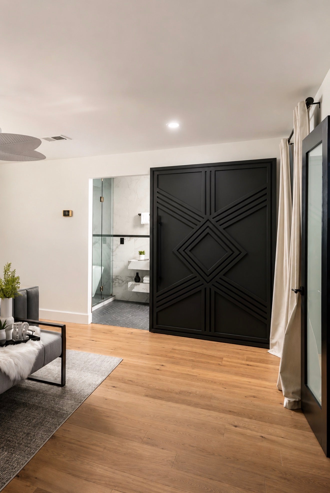 Giza Grand black sliding door installed in a modern luxury primary bedroom