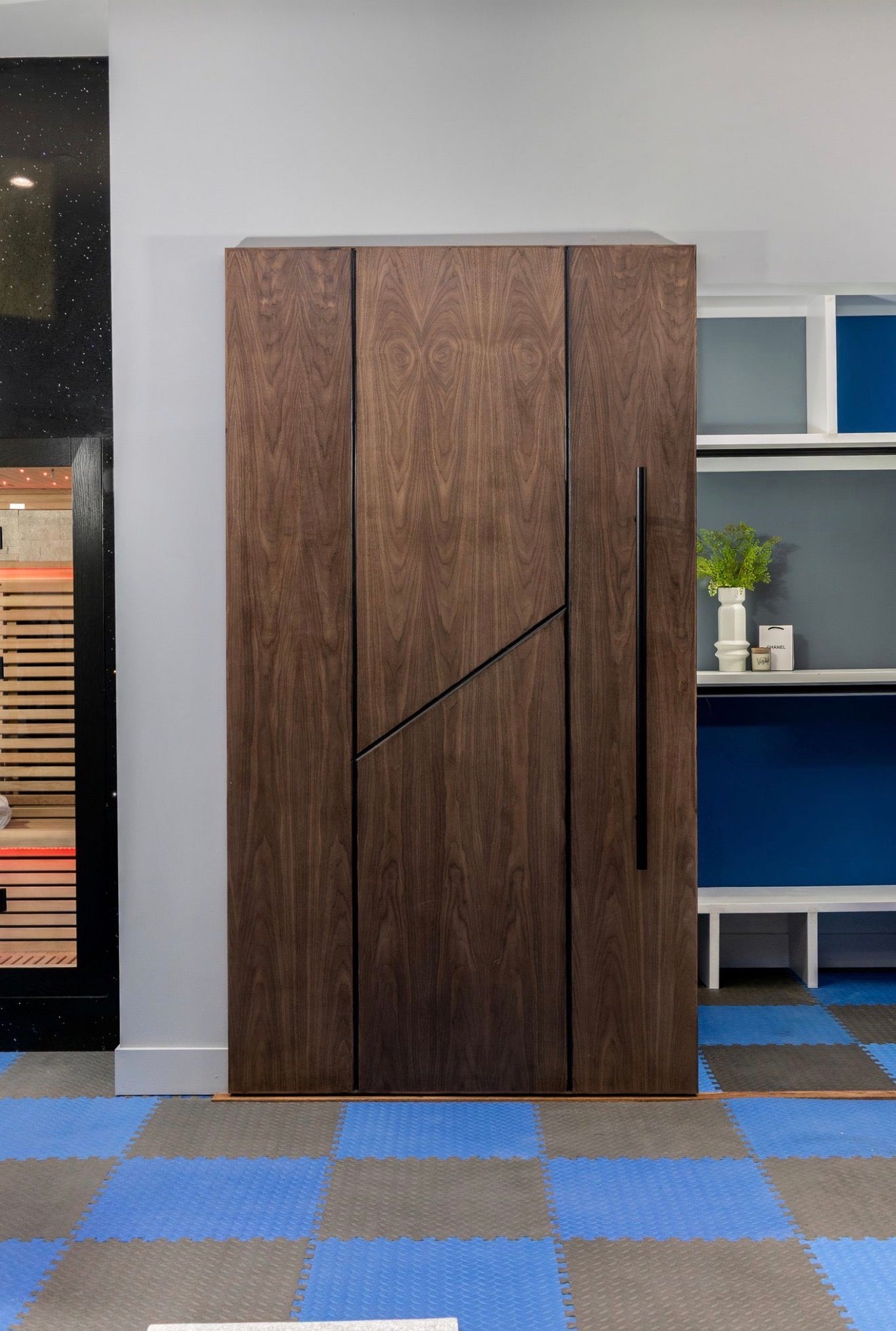 Nerano walnut interior door with Invisible Floating Slide™ concealed hardware and modern architectural design by Rustic Luxe Designs.
