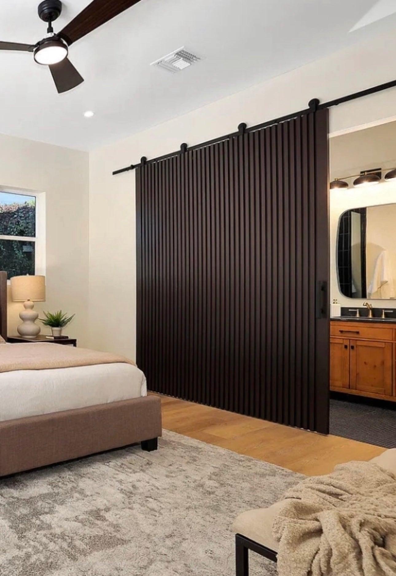 Solid slat interior door with vertical wood slats, modern minimalist Rakesh door by Rustic Luxe Designs.