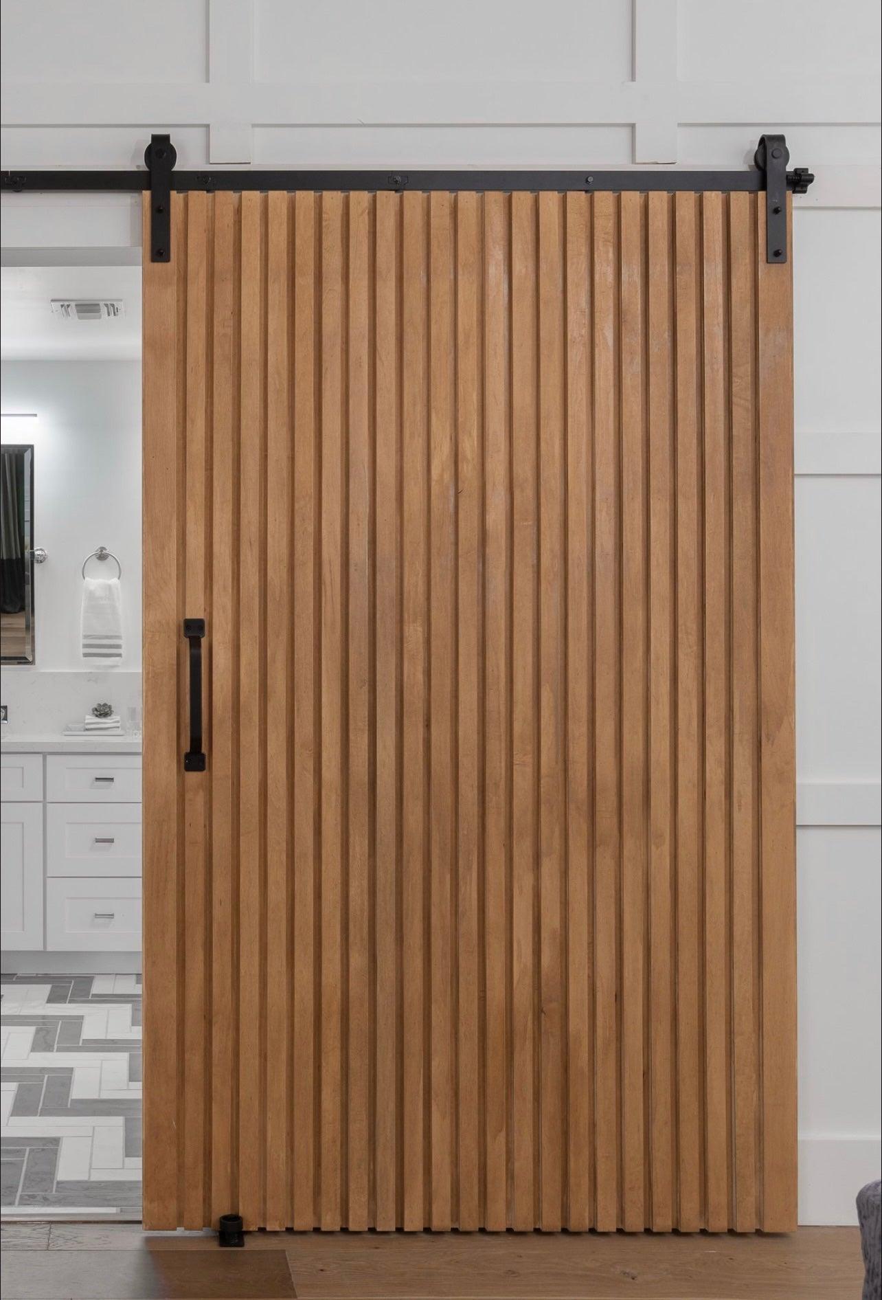 Custom solid vertical slat interior door, modern Rakesh wood door by Rustic Luxe Designs.