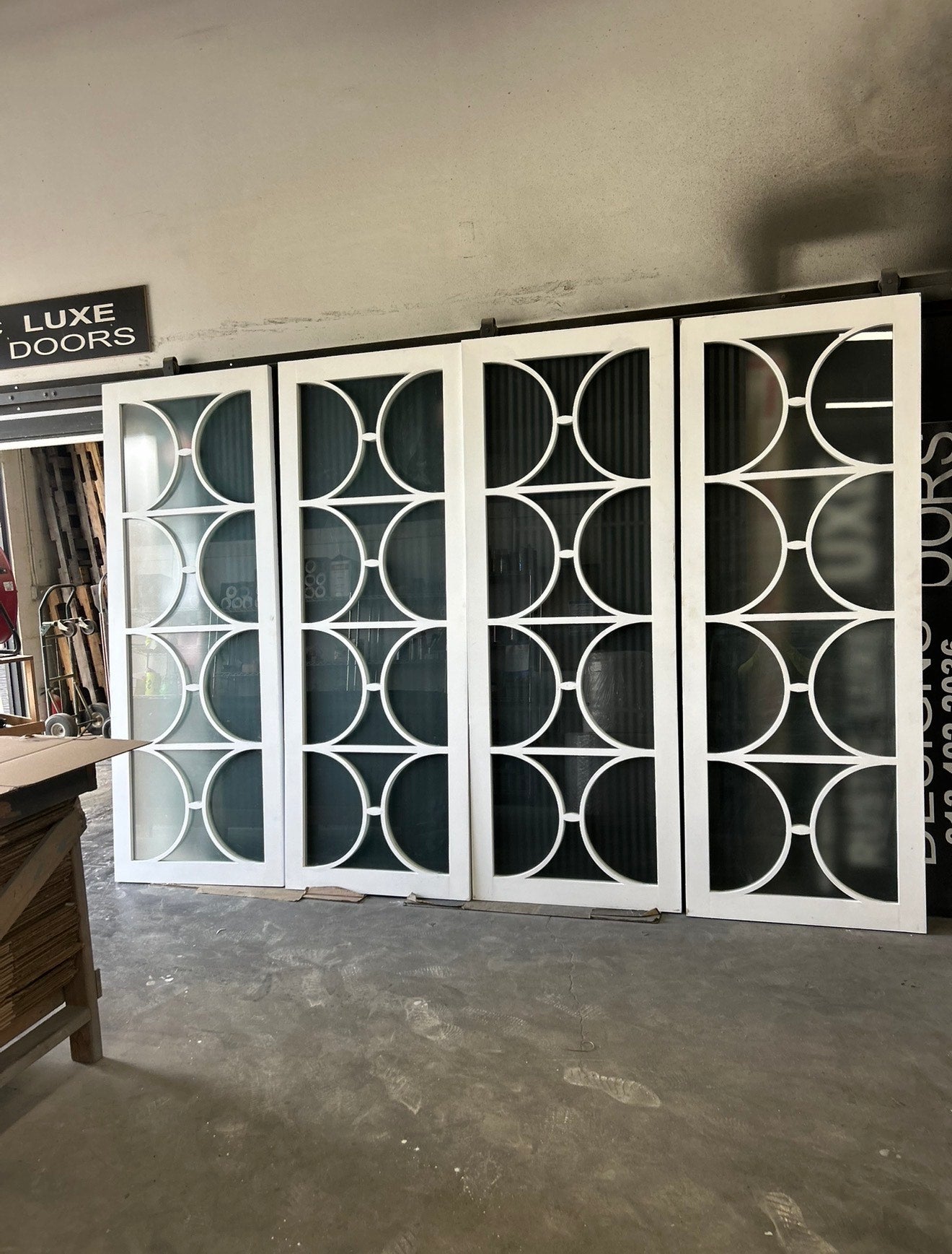 Decorative glass doors with geometric patterns in a storage or showroom setting.